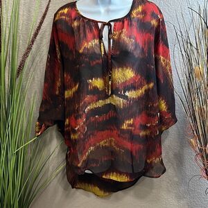 #126 Alan B. Schwartz. Batwing sleeve, Sheer print, high low top. Size large.